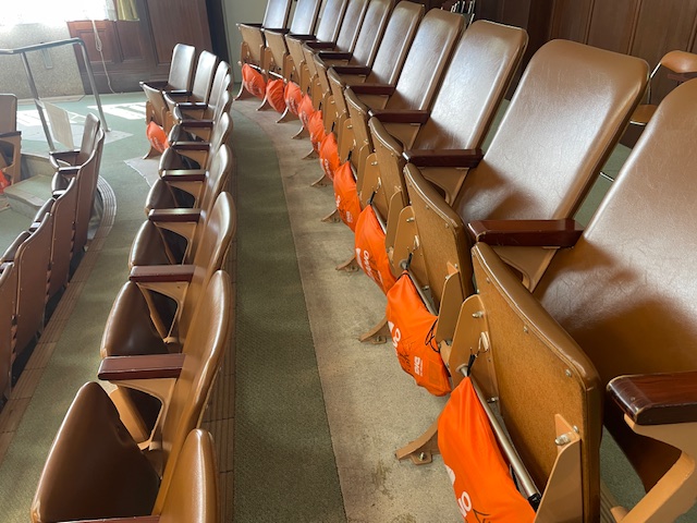 傍聴席の座席板下にヘルメットを据え付けていた